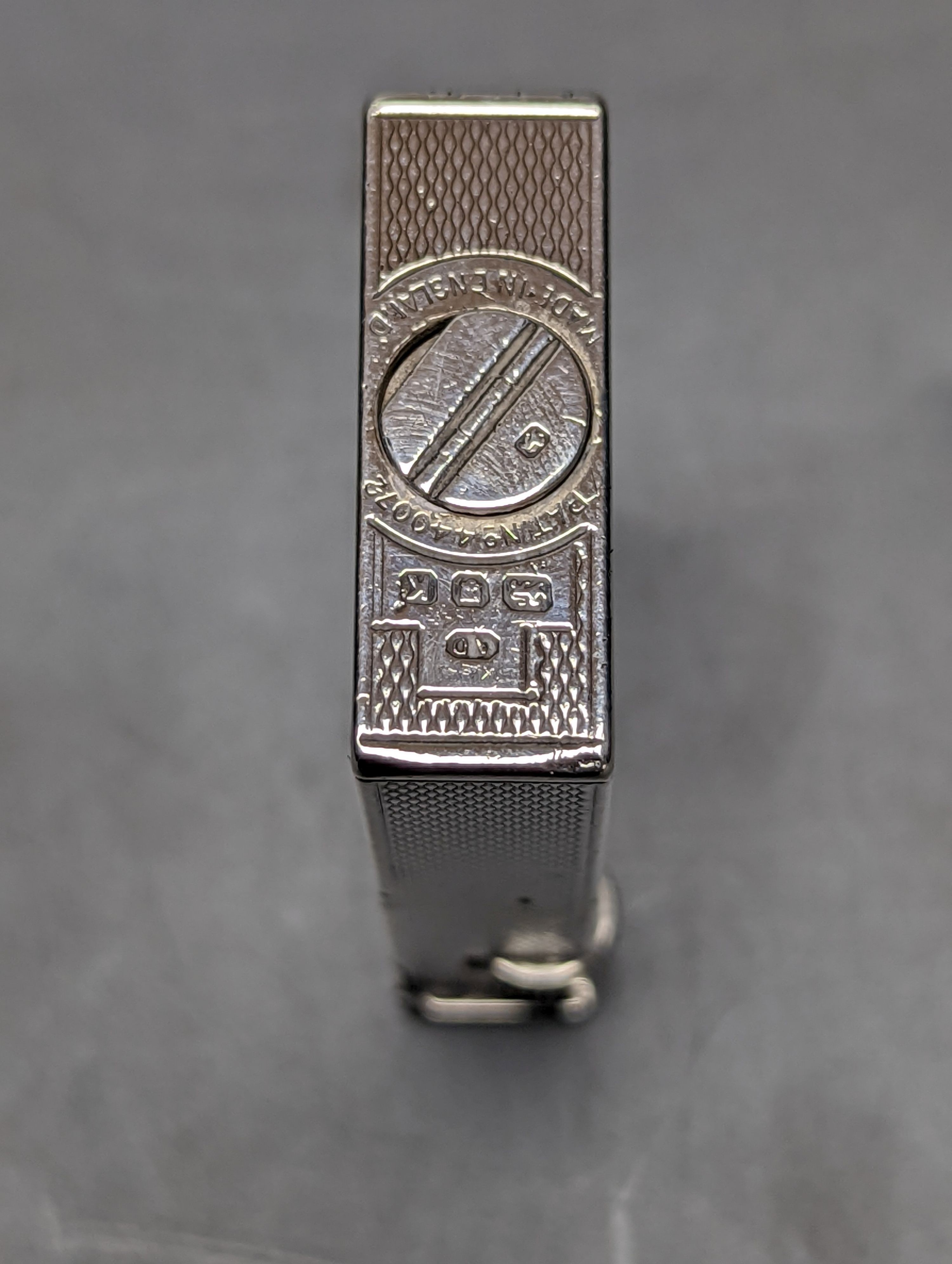 A George VI engine turned silver mounted Dunhill lighter, London, 1945, 57mm.